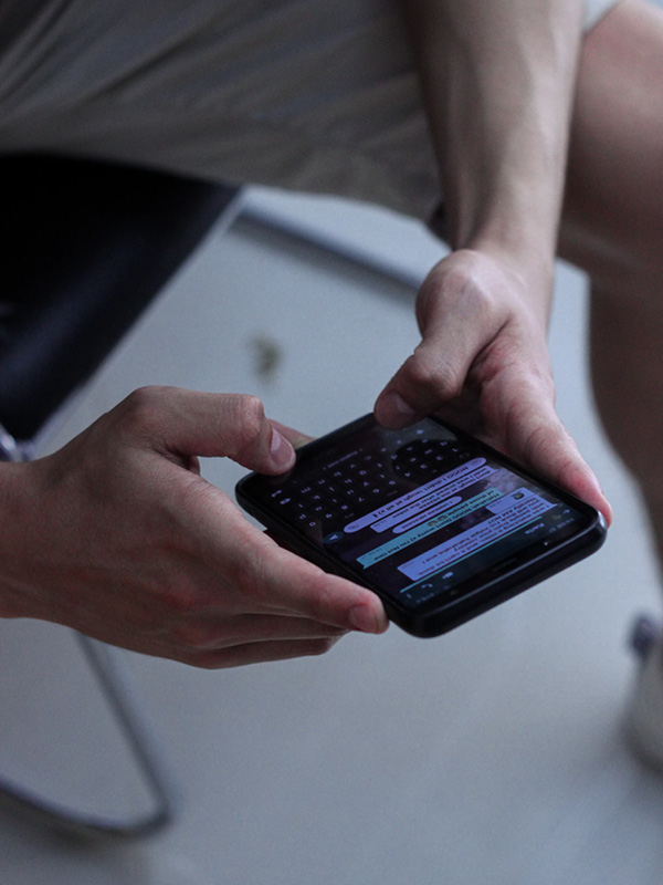 A mobile phone running WhatApp in someone's hands