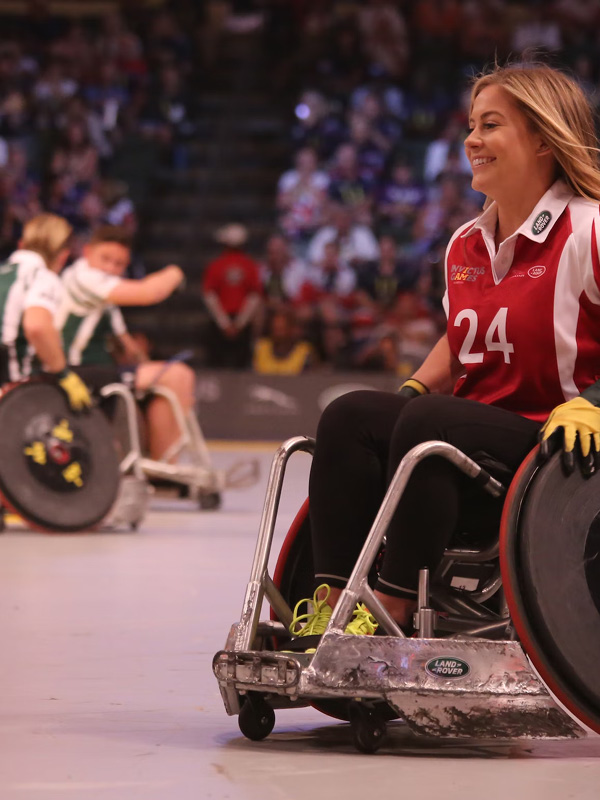 A woman in a wheelchair playing sport