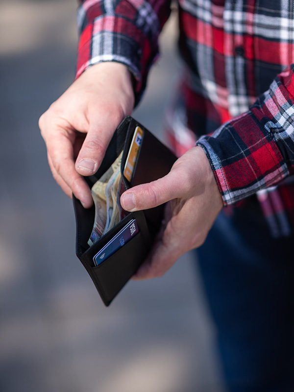 An open wallet containing cash and credit cards